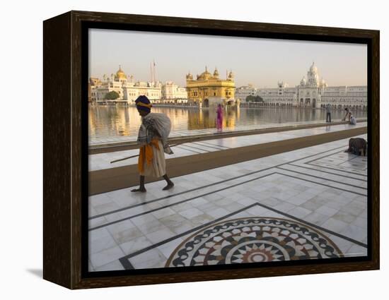 Elderly Sikh Pilgrim with Bundle and Stick Walking Around Holy Pool, Amritsar, India-Eitan Simanor-Framed Premier Image Canvas