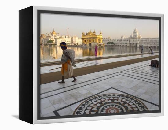 Elderly Sikh Pilgrim with Bundle and Stick Walking Around Holy Pool, Amritsar, India-Eitan Simanor-Framed Premier Image Canvas