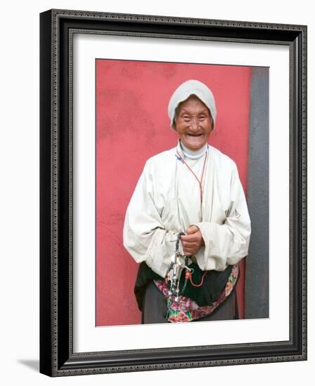 Elderly Tibetan Woman with Red Wall, Tagong, Sichuan, China-Keren Su-Framed Photographic Print