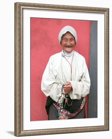 Elderly Tibetan Woman with Red Wall, Tagong, Sichuan, China-Keren Su-Framed Photographic Print