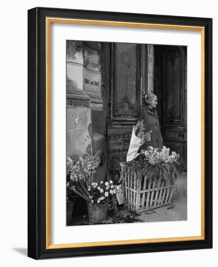 Elderly Woman Selling Flowers Outside Gallerie du Bac, Paris-Gjon Mili-Framed Photographic Print