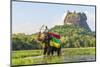 Elephant ride with Lion Rock, Ancient Rock Fortress behind, Sigiriya, Sri Lanka-Peter Adams-Mounted Photographic Print