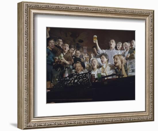 Elevated View of a Group of People as They Sing Along with a Pianist in a Unidentified Bar, 1959-Yale Joel-Framed Photographic Print