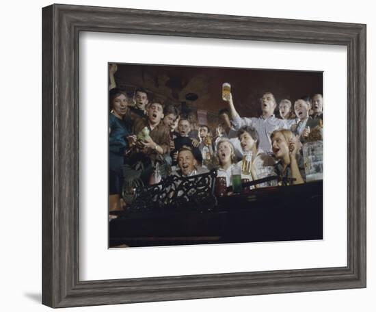 Elevated View of a Group of People as They Sing Along with a Pianist in a Unidentified Bar, 1959-Yale Joel-Framed Photographic Print