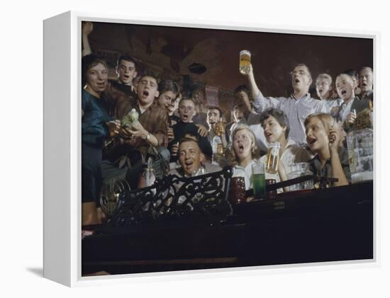 Elevated View of a Group of People as They Sing Along with a Pianist in a Unidentified Bar, 1959-Yale Joel-Framed Premier Image Canvas