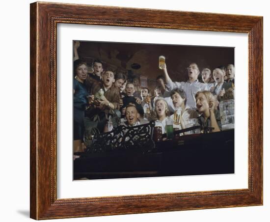 Elevated View of a Group of People as They Sing Along with a Pianist in a Unidentified Bar, 1959-Yale Joel-Framed Photographic Print