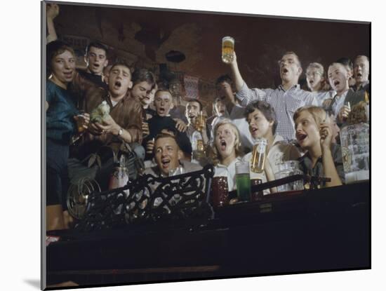 Elevated View of a Group of People as They Sing Along with a Pianist in a Unidentified Bar, 1959-Yale Joel-Mounted Photographic Print