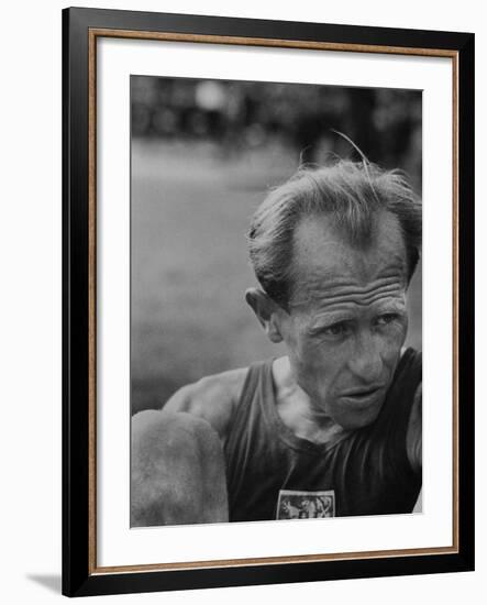 Emil Zatopek Sitting Tensely with Furrowed Brow after Winning Second of Three Olympic Races-Ralph Crane-Framed Premium Photographic Print