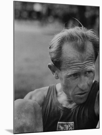 Emil Zatopek Sitting Tensely with Furrowed Brow after Winning Second of Three Olympic Races-Ralph Crane-Mounted Premium Photographic Print