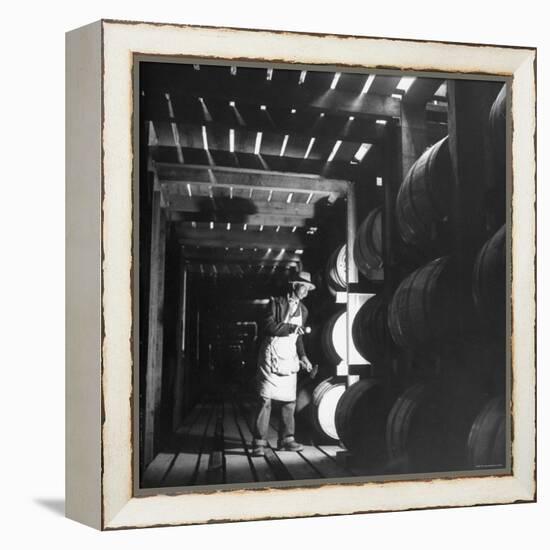 Employee in Warehouse of Jack Daniels Distillery Checking For Leaks in the Barrels-Ed Clark-Framed Premier Image Canvas