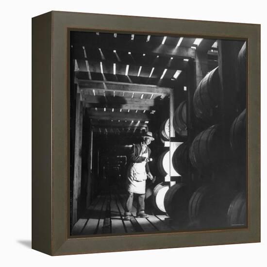 Employee in Warehouse of Jack Daniels Distillery Checking For Leaks in the Barrels-Ed Clark-Framed Premier Image Canvas