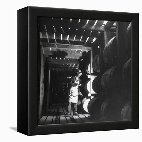 Employee in Warehouse of Jack Daniels Distillery Checking For Leaks in the Barrels-Ed Clark-Framed Premier Image Canvas