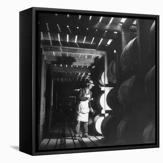 Employee in Warehouse of Jack Daniels Distillery Checking For Leaks in the Barrels-Ed Clark-Framed Premier Image Canvas