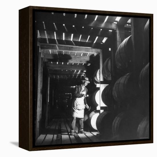 Employee in Warehouse of Jack Daniels Distillery Checking For Leaks in the Barrels-Ed Clark-Framed Premier Image Canvas