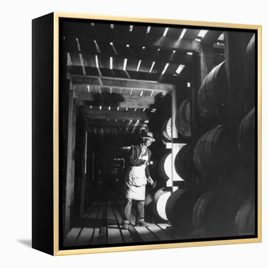 Employee in Warehouse of Jack Daniels Distillery Checking For Leaks in the Barrels-Ed Clark-Framed Premier Image Canvas