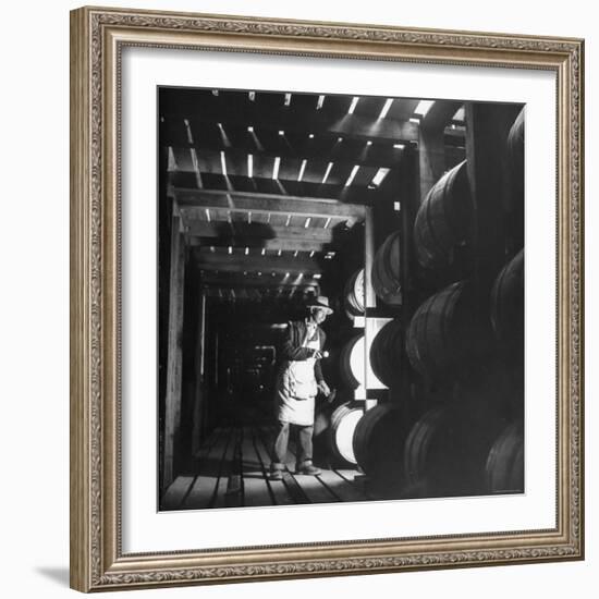 Employee in Warehouse of Jack Daniels Distillery Checking For Leaks in the Barrels-Ed Clark-Framed Photographic Print