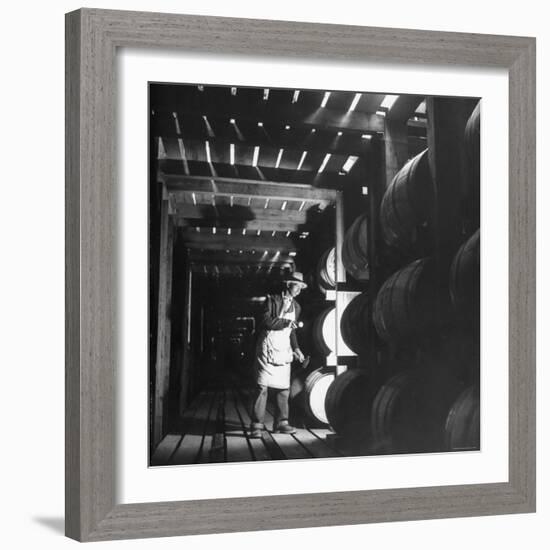 Employee in Warehouse of Jack Daniels Distillery Checking For Leaks in the Barrels-Ed Clark-Framed Photographic Print