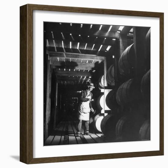 Employee in Warehouse of Jack Daniels Distillery Checking For Leaks in the Barrels-Ed Clark-Framed Photographic Print