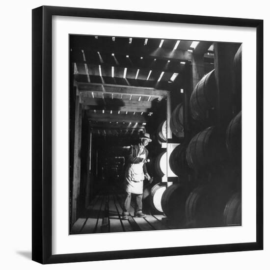 Employee in Warehouse of Jack Daniels Distillery Checking For Leaks in the Barrels-Ed Clark-Framed Photographic Print