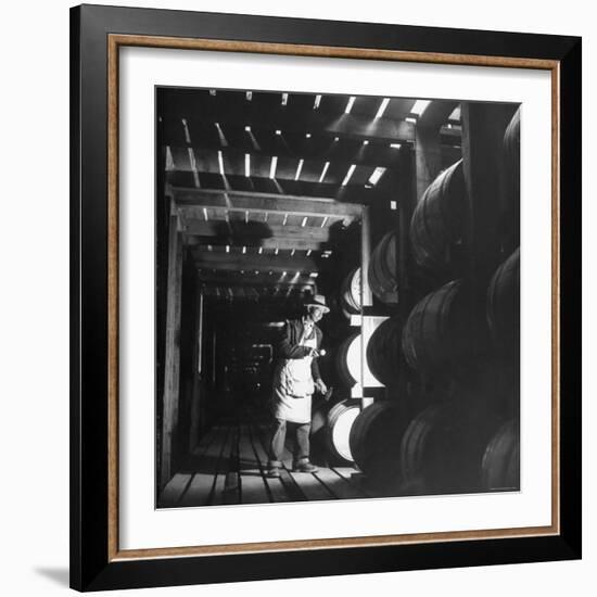 Employee in Warehouse of Jack Daniels Distillery Checking For Leaks in the Barrels-Ed Clark-Framed Photographic Print