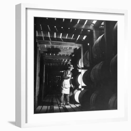 Employee in Warehouse of Jack Daniels Distillery Checking For Leaks in the Barrels-Ed Clark-Framed Photographic Print