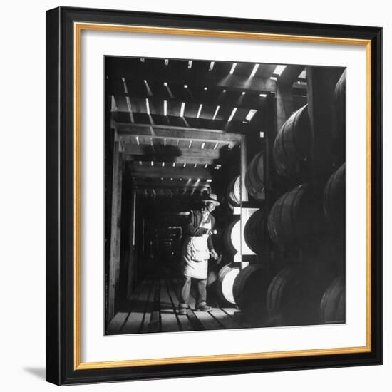 Employee in Warehouse of Jack Daniels Distillery Checking For Leaks in the Barrels-Ed Clark-Framed Photographic Print