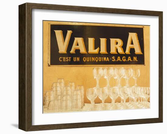 Empty Wine & Water Glasses in Front of Valira Publicity Sign-Peter Medilek-Framed Photographic Print