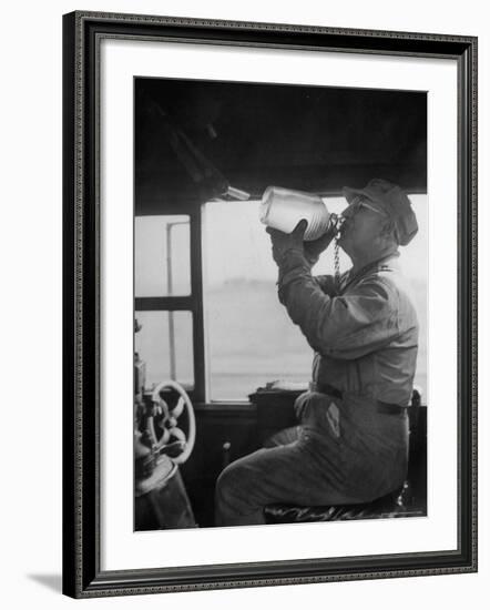 Engineer in the 20th Century Limited Drinking Water from Glass Jug He Kept Underneath His Stool-Alfred Eisenstaedt-Framed Photographic Print