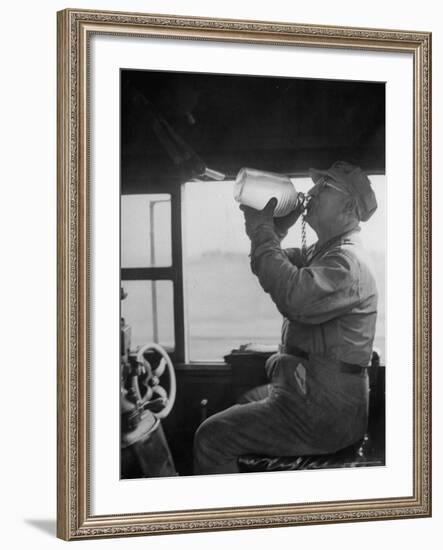 Engineer in the 20th Century Limited Drinking Water from Glass Jug He Kept Underneath His Stool-Alfred Eisenstaedt-Framed Photographic Print