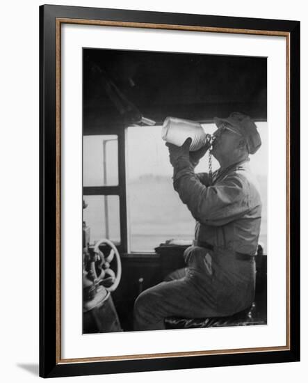 Engineer in the 20th Century Limited Drinking Water from Glass Jug He Kept Underneath His Stool-Alfred Eisenstaedt-Framed Photographic Print