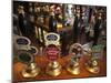 England, London, Beer Pump Handles at the Bar Inside Tradional Pub-Steve Vidler-Mounted Photographic Print