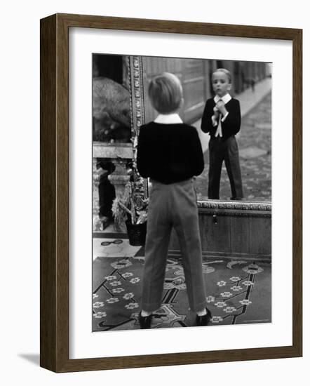 English Boy Using Reflection in Mirror in Foyer of Grand Hotel to Fix His Tie-Alfred Eisenstaedt-Framed Photographic Print