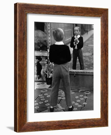 English Boy Using Reflection in Mirror in Foyer of Grand Hotel to Fix His Tie-Alfred Eisenstaedt-Framed Photographic Print