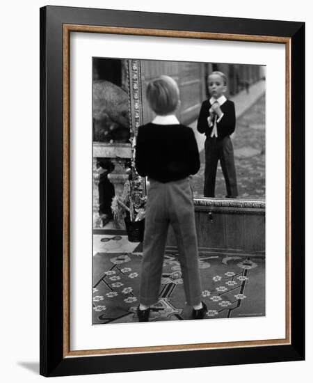 English Boy Using Reflection in Mirror in Foyer of Grand Hotel to Fix His Tie-Alfred Eisenstaedt-Framed Photographic Print