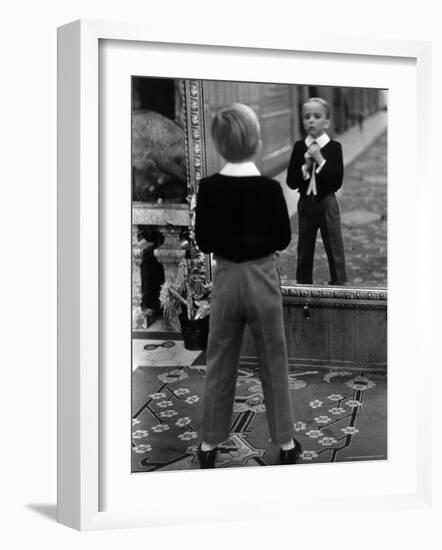 English Boy Using Reflection in Mirror in Foyer of Grand Hotel to Fix His Tie-Alfred Eisenstaedt-Framed Photographic Print