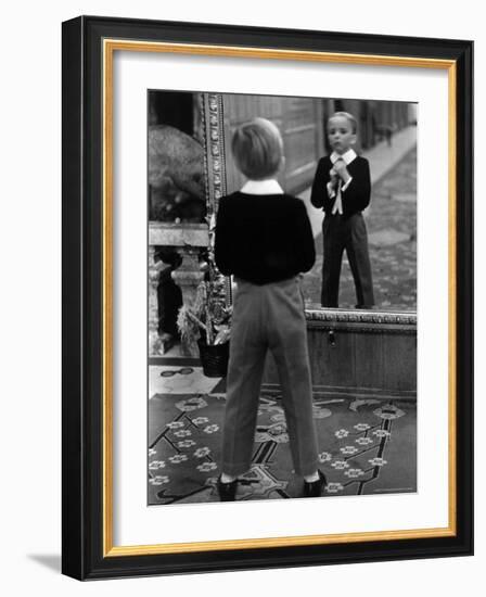 English Boy Using Reflection in Mirror in Foyer of Grand Hotel to Fix His Tie-Alfred Eisenstaedt-Framed Photographic Print