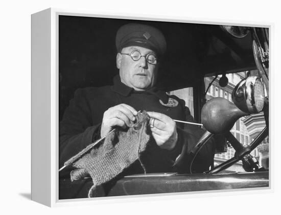 English Cabby Dutifully Knitting Sweater For British Soldier as He Waits at Taxi Rack on Oxford St-Carl Mydans-Framed Premier Image Canvas