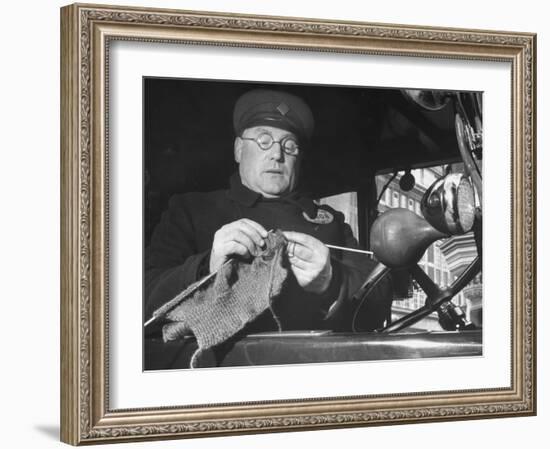 English Cabby Dutifully Knitting Sweater For British Soldier as He Waits at Taxi Rack on Oxford St-Carl Mydans-Framed Photographic Print