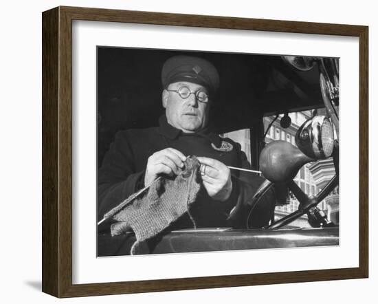English Cabby Dutifully Knitting Sweater For British Soldier as He Waits at Taxi Rack on Oxford St-Carl Mydans-Framed Photographic Print