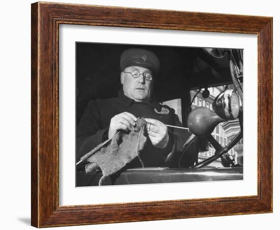 English Cabby Dutifully Knitting Sweater For British Soldier as He Waits at Taxi Rack on Oxford St-Carl Mydans-Framed Photographic Print