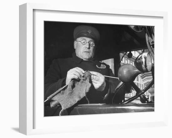 English Cabby Dutifully Knitting Sweater For British Soldier as He Waits at Taxi Rack on Oxford St-Carl Mydans-Framed Photographic Print