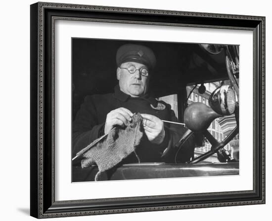 English Cabby Dutifully Knitting Sweater For British Soldier as He Waits at Taxi Rack on Oxford St-Carl Mydans-Framed Photographic Print