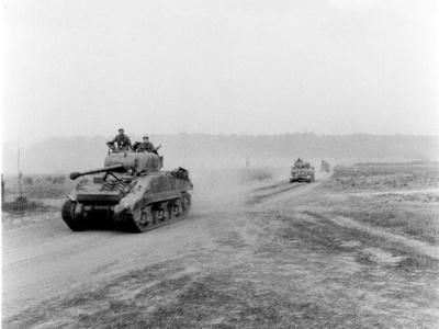 https://imgc.artprintimages.com/img/print/english-photographer-tanks-on-the-move-to-vire-over-the-tank-runs-c-1945_u-l-pjjxpt0.jpg?background=f3f3f3
