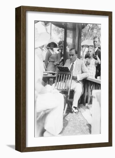 Enrico Caruso Leans Back on Chair Holding a Board with Music-null-Framed Art Print