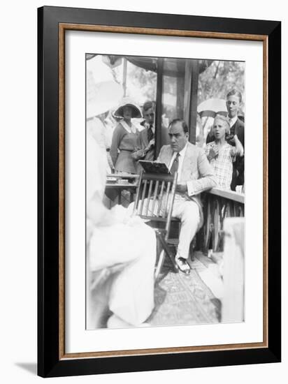 Enrico Caruso Leans Back on Chair Holding a Board with Music-null-Framed Art Print