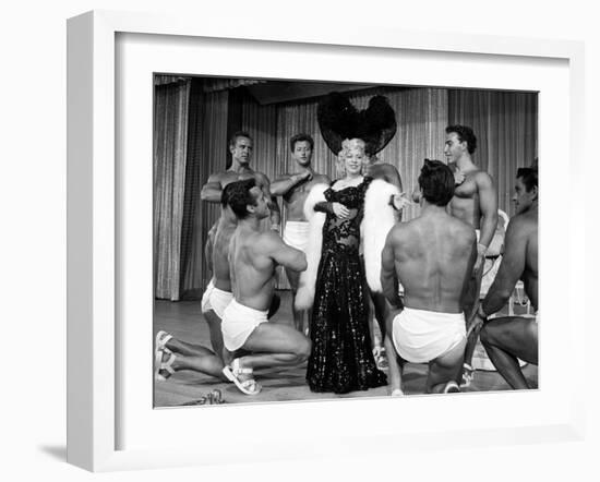 Entertainer Mae West Making Her Nightclub Debut with Loin-Clothed Dancers at Hotel Sahara-Loomis Dean-Framed Photographic Print