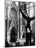 Entrance to St. Patrick's Visible Across Fifth Avenue, with Atlas Statue Silhouetted in Foreground-Andreas Feininger-Mounted Photographic Print