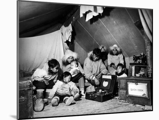 Eskimo Family Admiring their Modern Conveniences, a Victrola, a Sewing Machine and a Stove-Margaret Bourke-White-Mounted Photographic Print