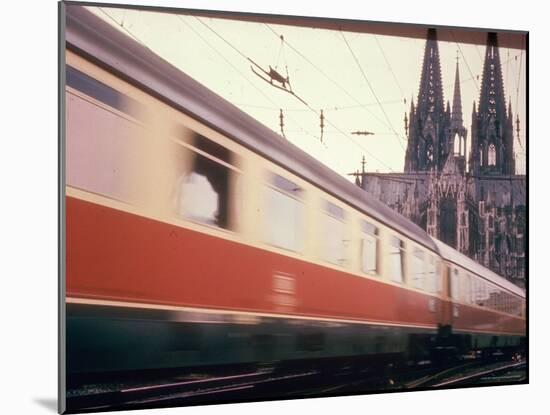 Eurailpass in Europe: Germany's Parsifal Express Speeding Past Cologne Cathedral-Carlo Bavagnoli-Mounted Photographic Print