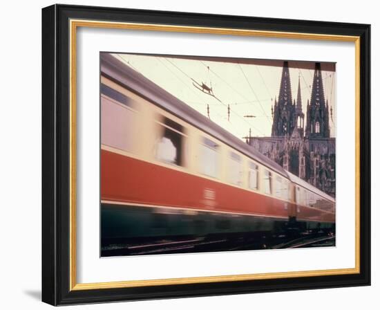 Eurailpass in Europe: Germany's Parsifal Express Speeding Past Cologne Cathedral-Carlo Bavagnoli-Framed Photographic Print